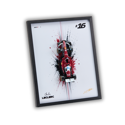 A framed art print featuring a red Formula 1 race car with black and red paint splatters on a white background, enclosed in a black frame. The print includes the number 16, the name Charles Leclerc, and a signature.
