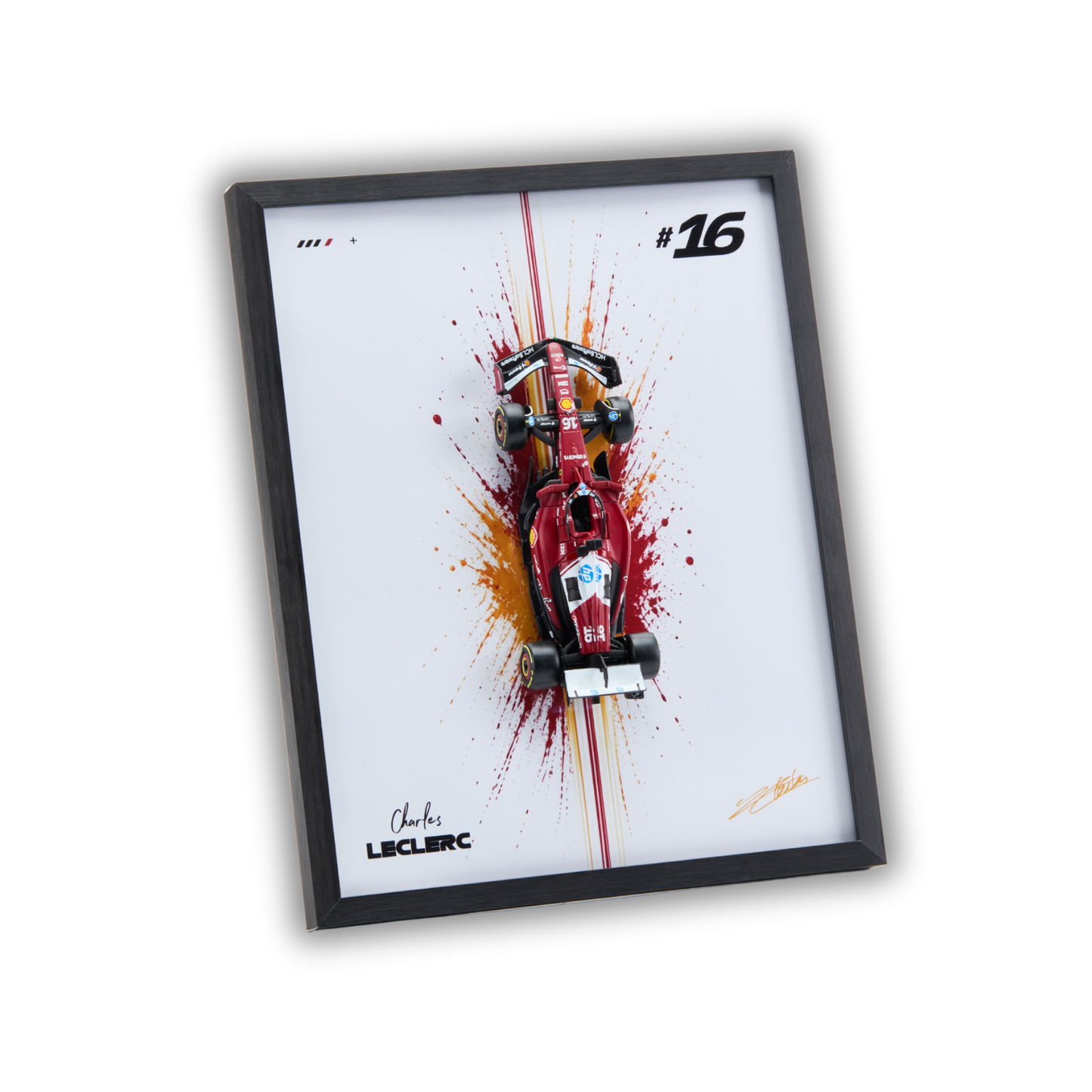 A framed art print featuring a red Formula 1 race car on a white background with paint splatter effects, a black frame, and the name Charles Leclerc printed at the bottom.