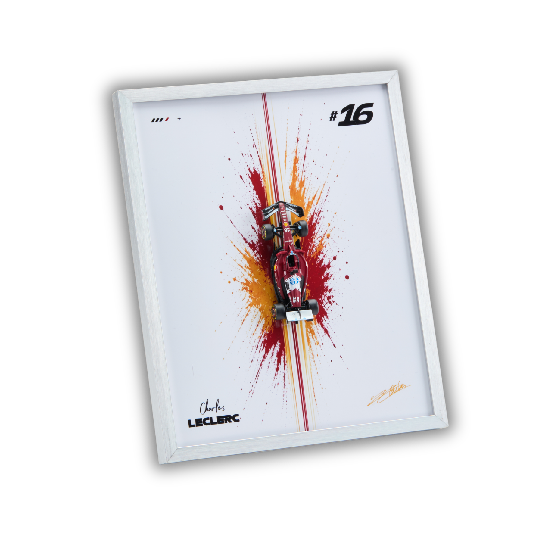 A framed wall art print featuring a red and black Formula 1 race car centered over a red and orange paint splash on a white background, with the number 16 and Charles Leclerc signatures.