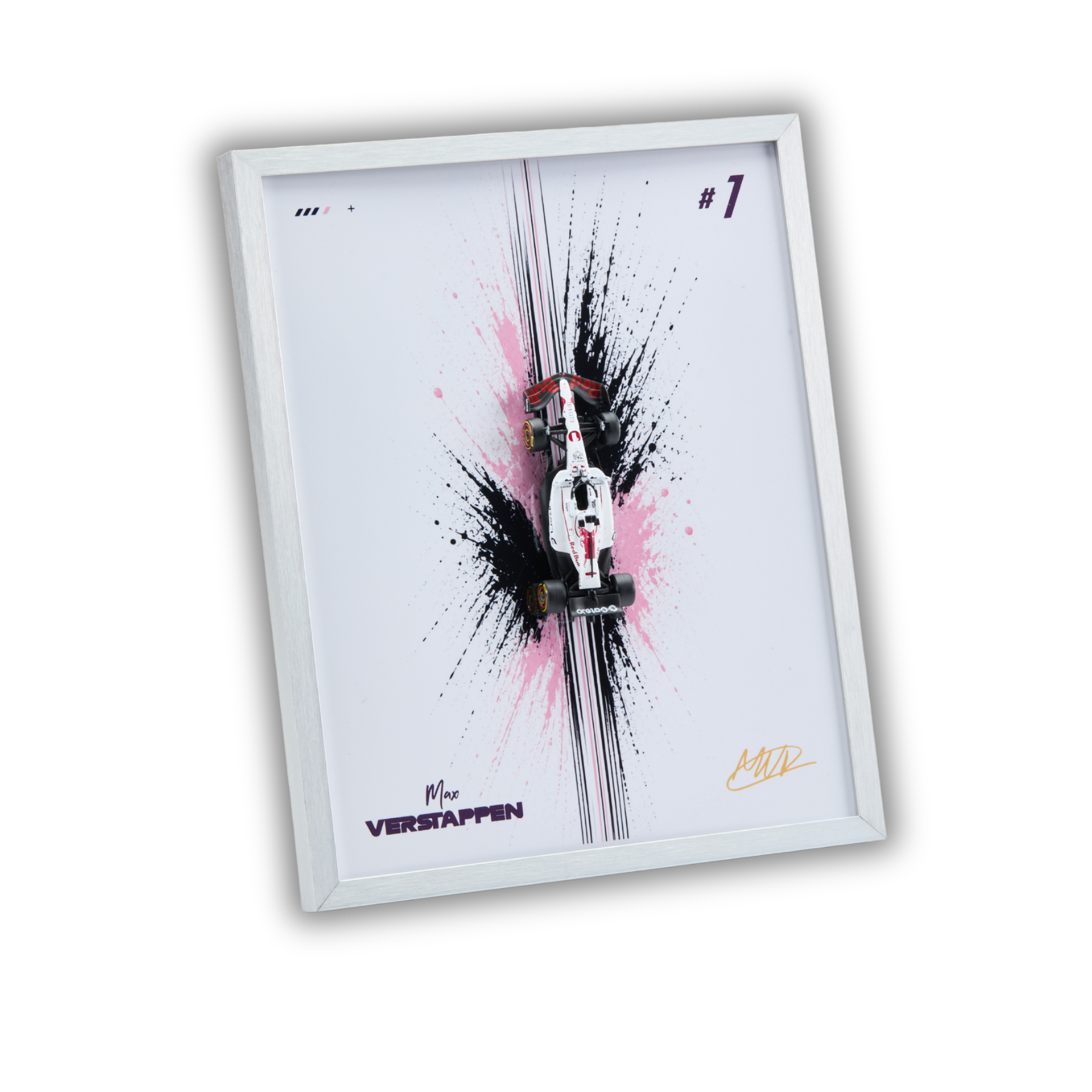 A framed art print featuring a miniature white and red Formula 1 race car on a white background with black and pink paint splatters, displayed in a white frame at an angle.