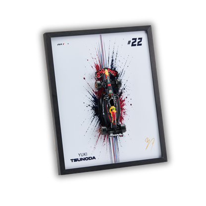 A framed art print featuring a stylized Red Bull Racing F1 car on a white background with red, black, and blue paint splatters, the number 22, and Yuki Tsuda branding.
