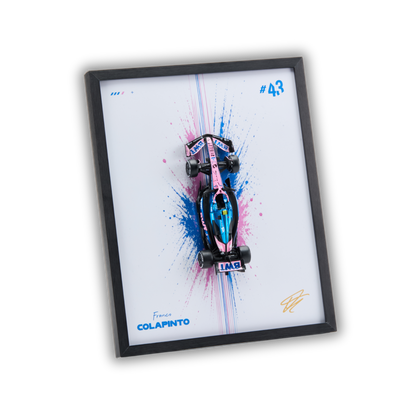 A framed wall art print featuring a pink and blue miniature Formula 1 race car mounted over a white background with paint splatter graphics. The print includes the text 'France COLAPINTO', '#43', and a gold signature, all enclosed in a black frame on a white background.