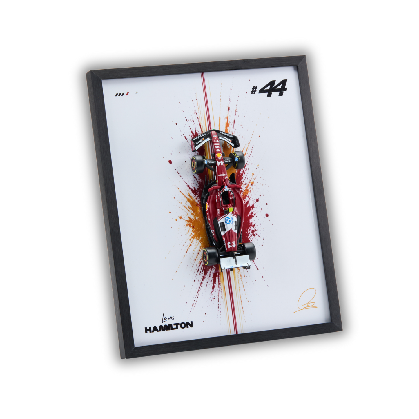 A framed art print featuring a red and white Formula 1 car on a white background with paint splatter effects, a black frame, and the text 'HAMILTON' and '#44'.