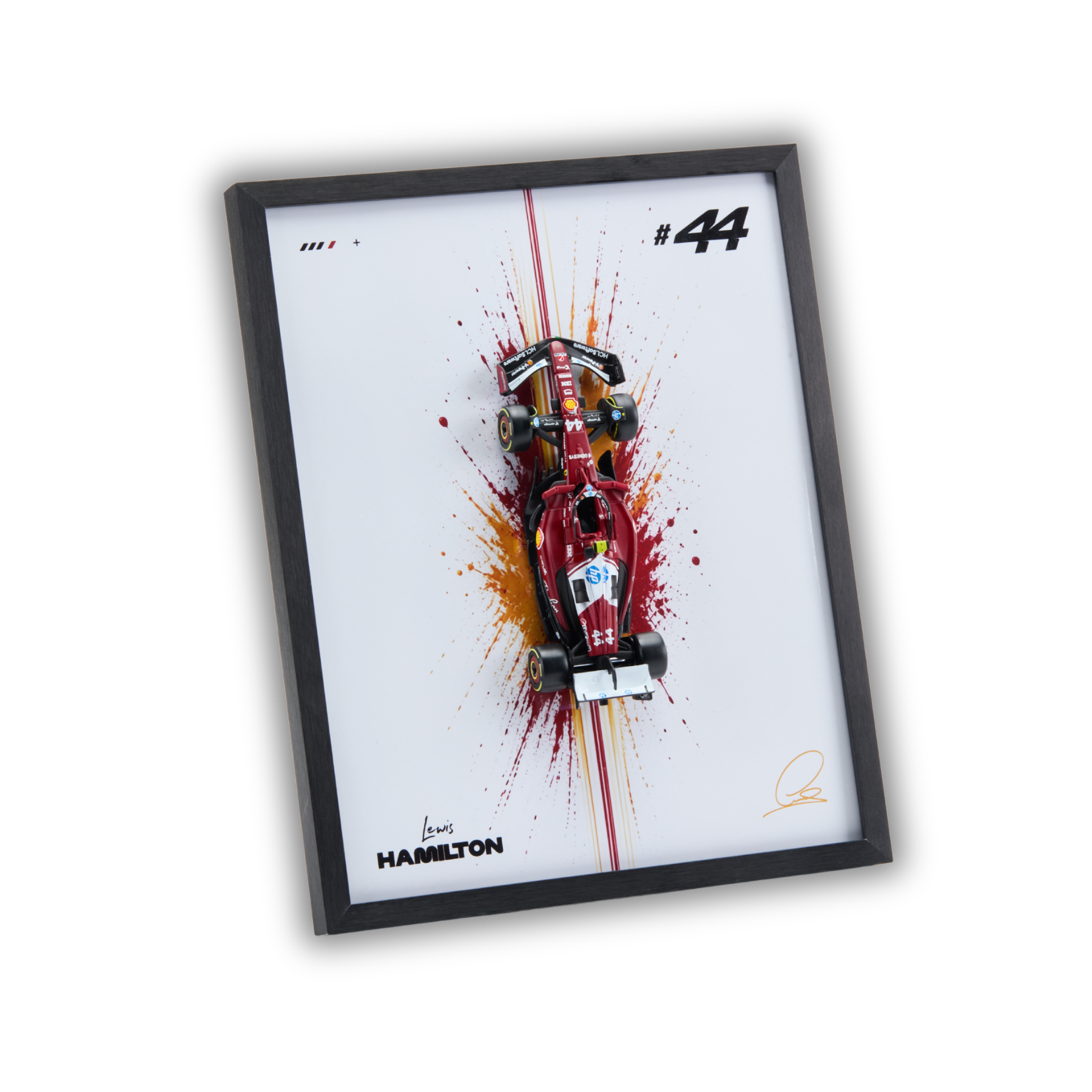 A framed art print featuring a red and white Formula 1 car on a white background with paint splatter effects, a black frame, and the text 'HAMILTON' and '#44'.