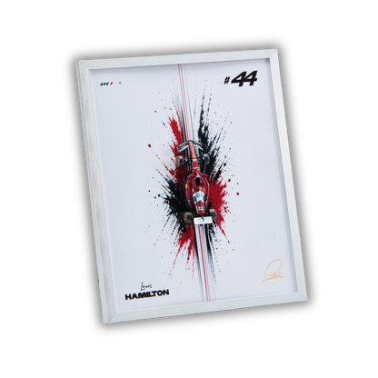 A framed art print featuring a stylized red and black Formula 1 car splash design on a white background, with the number 44, Hamilton branding, and a silver frame, shown on a plain white background.
