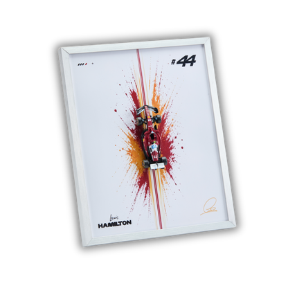 A framed wall art print featuring a miniature red race car mounted over a colorful paint splatter design on a white background, with the number 44, the name Hamilton, and signatures visible.