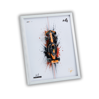A framed art print featuring a top-down view of an orange and black Formula 1 race car over a white background with black, red, and white paint splatters. The print includes the text '#4' and 'Lando NORRIS' along with a signature, housed in a white frame.