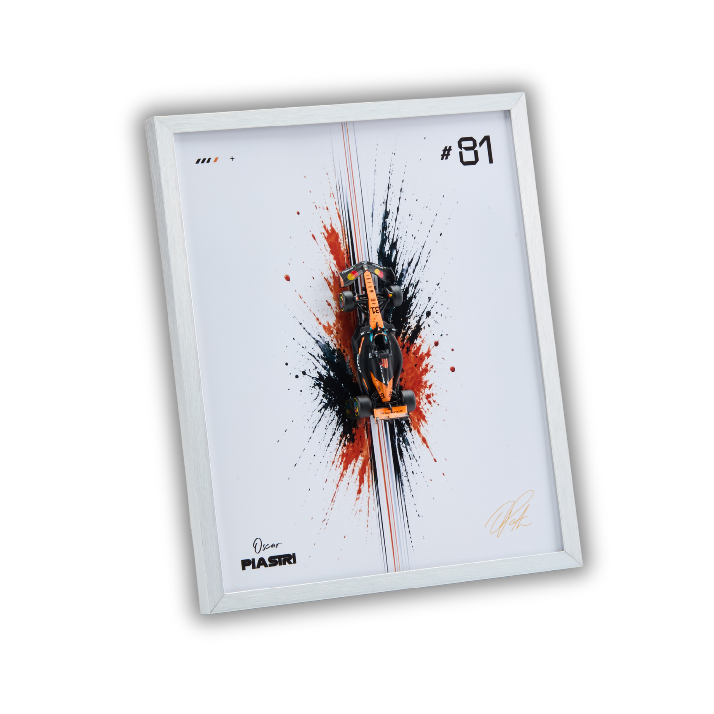 A framed art print featuring a stylized orange and black Formula 1 car centered over a white background with paint splatters. The print includes the text '#81' and 'PIASIRI' near the bottom, with a white frame shown against a plain white background.
